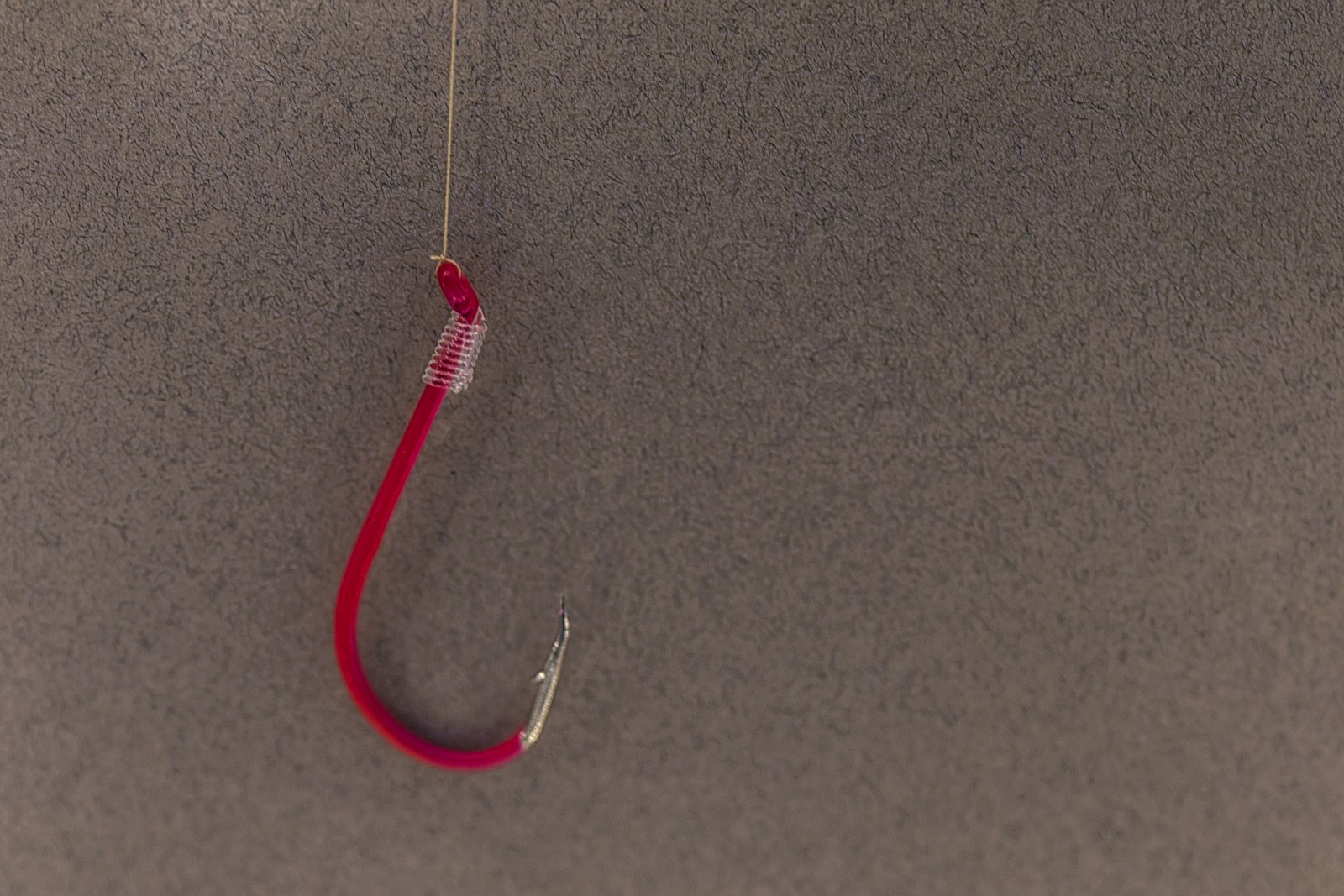 a red fishing hook hanging from a hook
