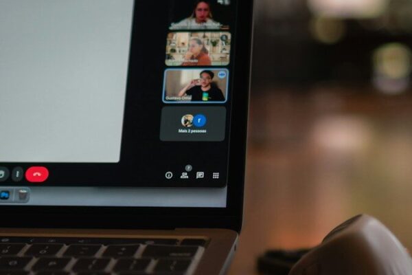 Laptop screen showing a video conference with multiple participants