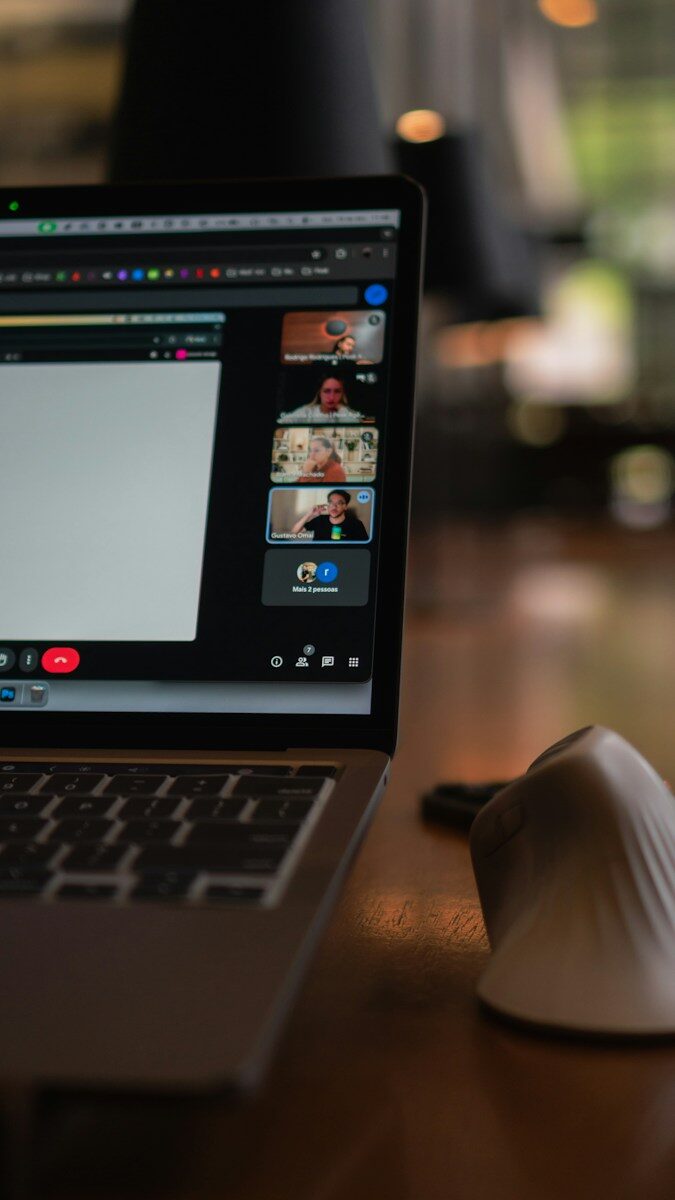 Laptop screen showing a video conference with multiple participants